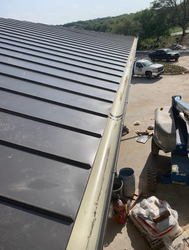 Standing seam panel and gutter detail on a metal roofing jobsite in Bridgeport